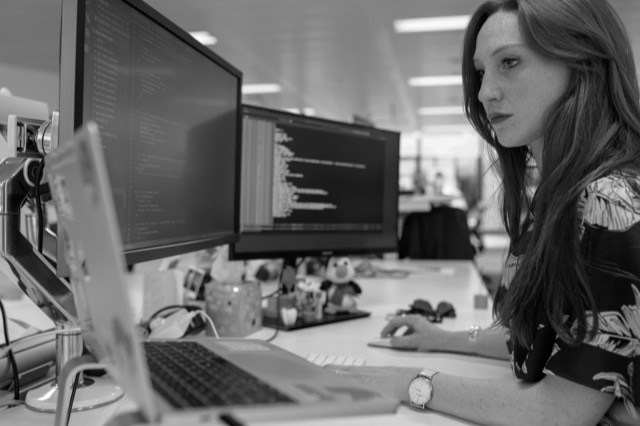 Woman reviewing code at computer