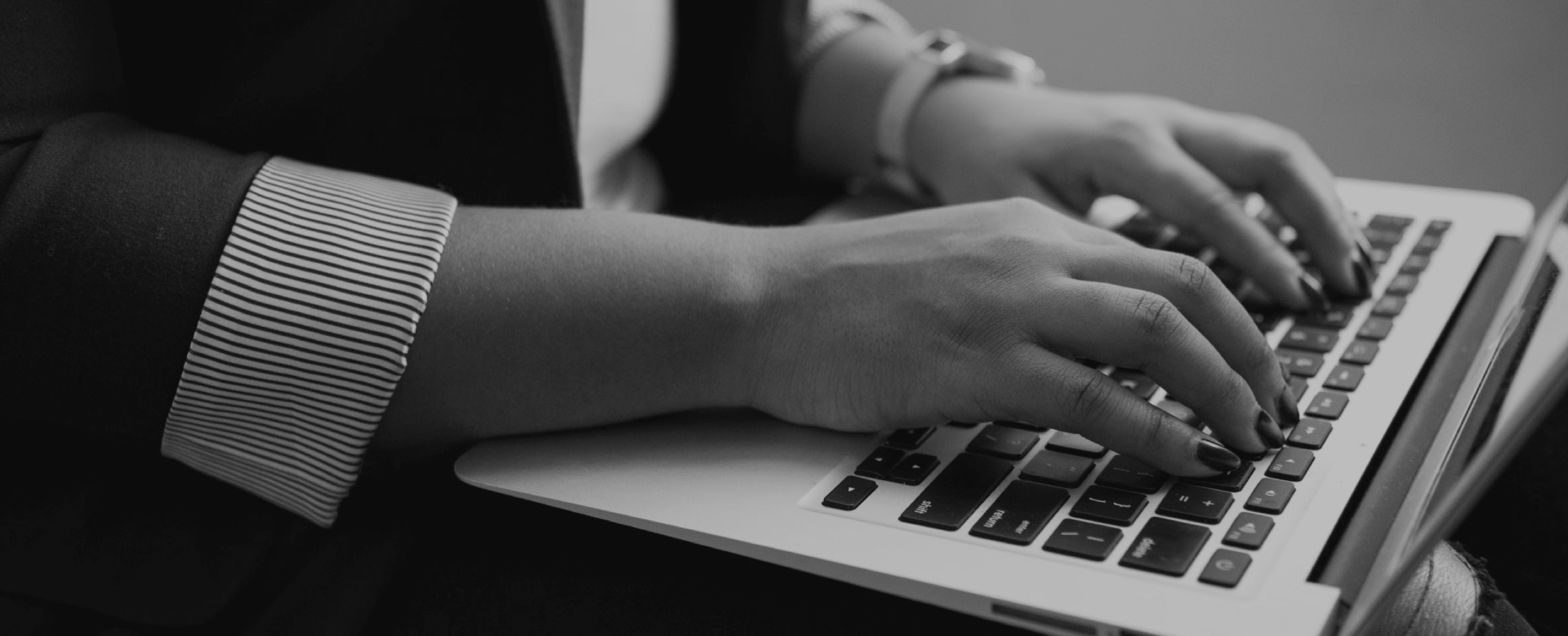 User's hands on laptop keyboard